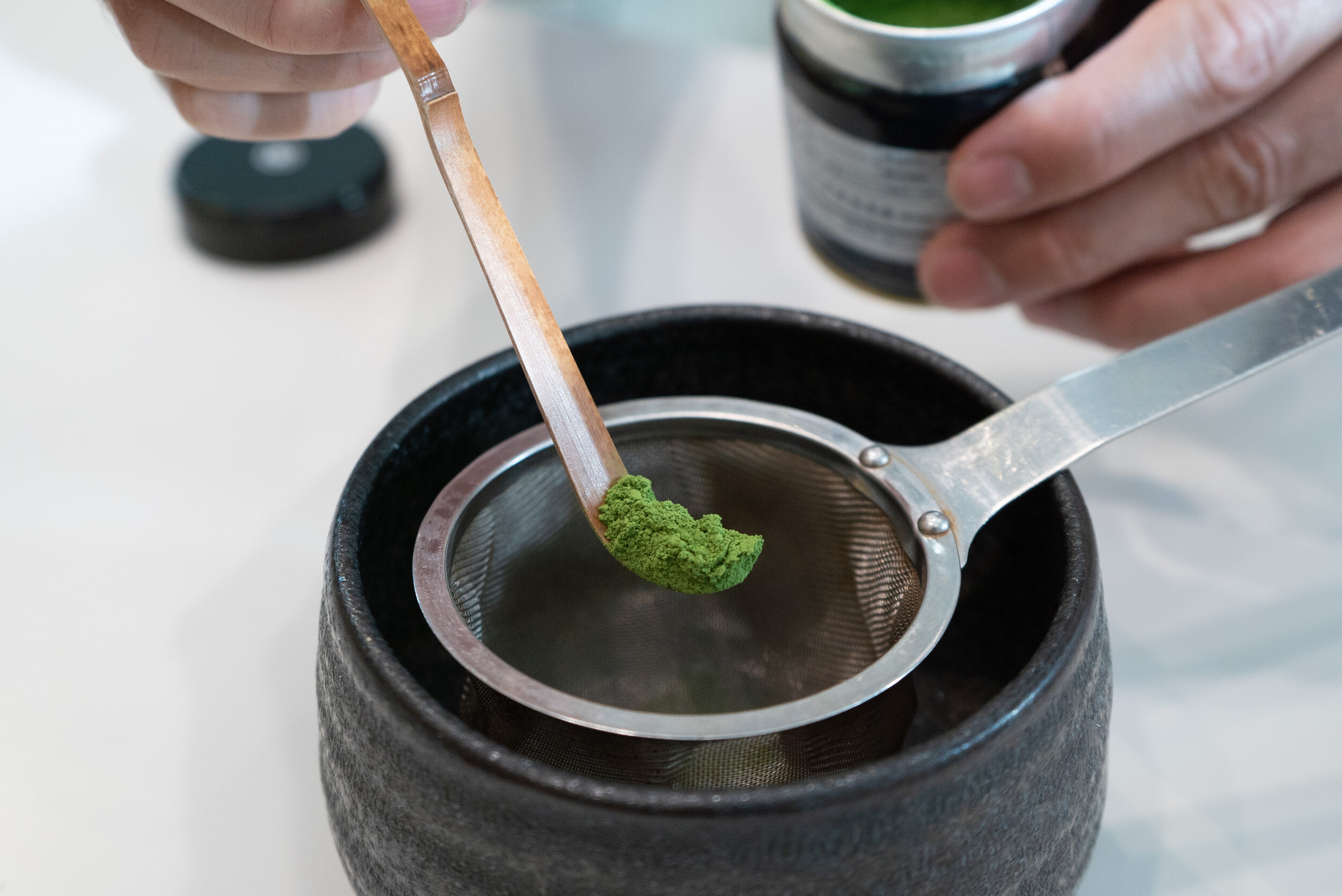 Sifting matcha powder through sieve